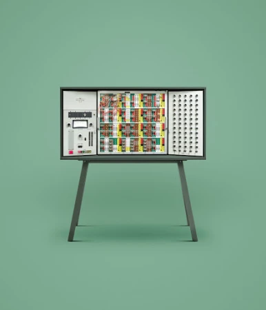 Vintage modular analog synthesizer set on a pale green background. The electronic instrument rests on a gray stand with splayed legs.