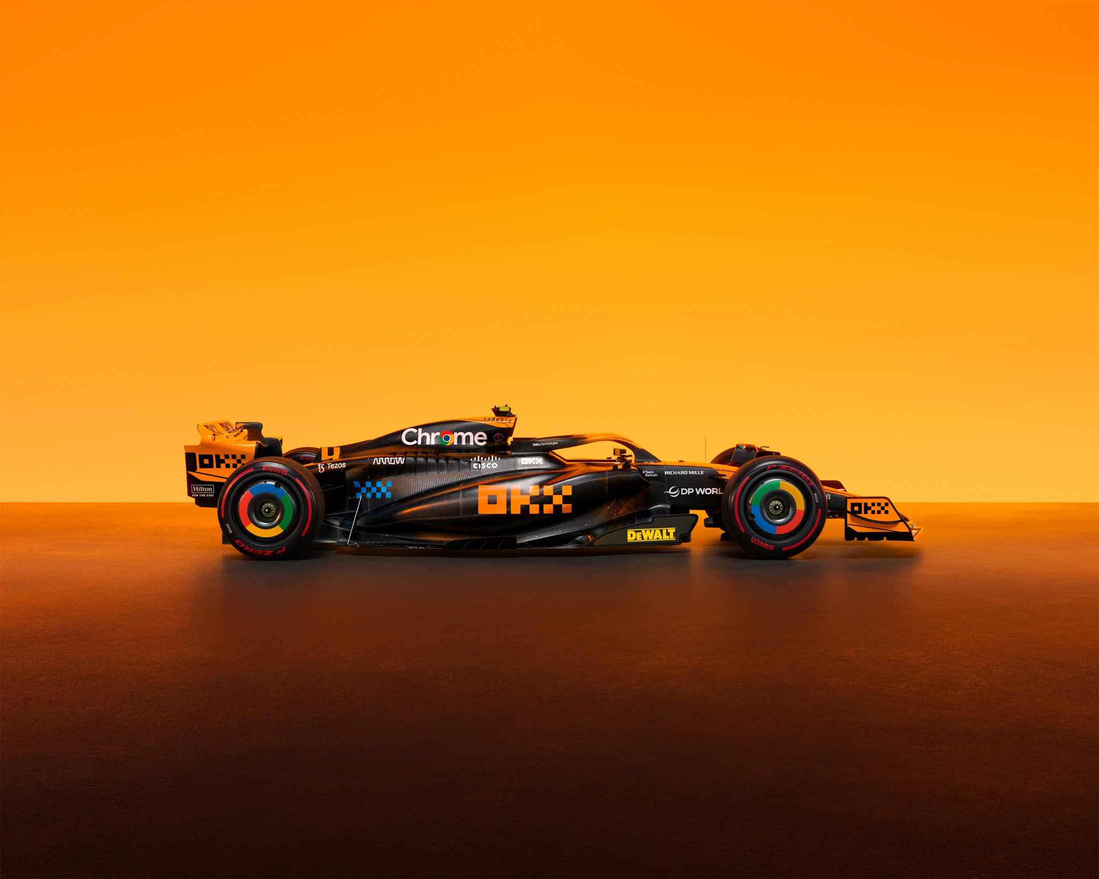 McLaren Formula 1 race car in black and orange livery, side view, studio shot, vivid colors.