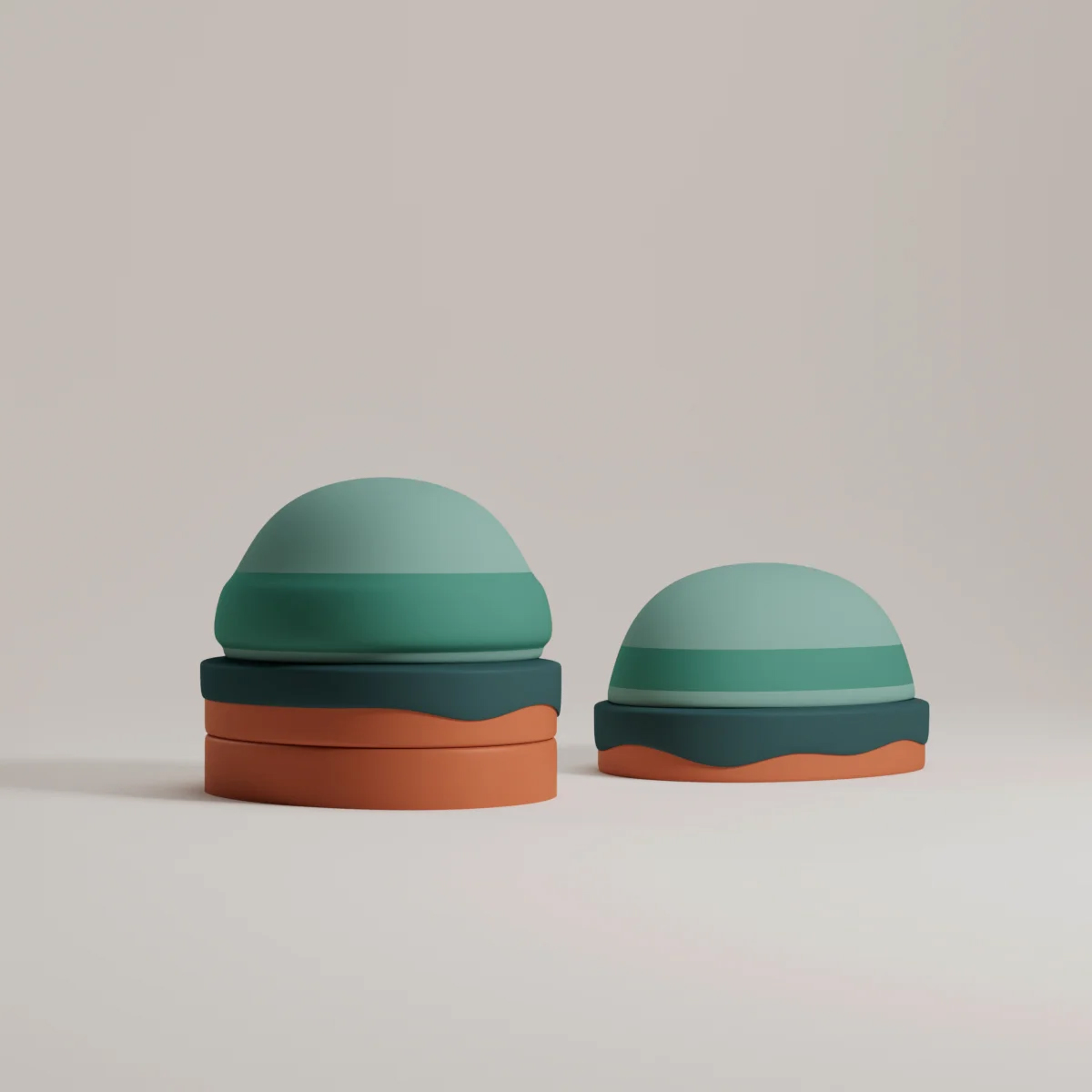 Two stacked, dome-shaped objects in shades of green and orange, set against a plain background. Perfect for abstract product display.