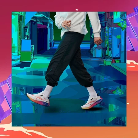 Person wearing white sweatshirt, black sweatpants, and white sneakers walks in front of an animated street. Cartoon background.