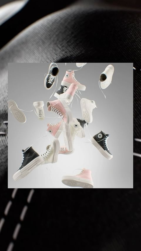 Floating collection of Converse Chuck Taylor All Star sneakers in white, pink, and black against a gradient gray background.
