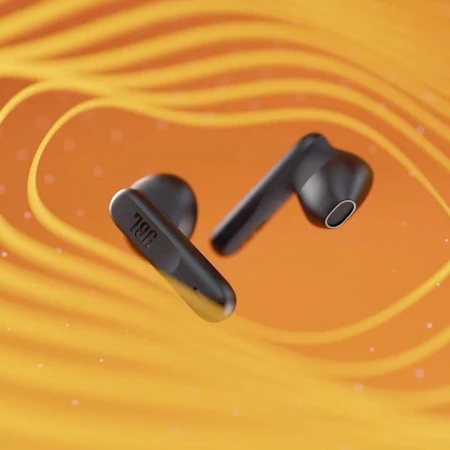 Close-up product shot of black JBL wireless earbuds with an orange background and abstract lighting effect for visual interest.