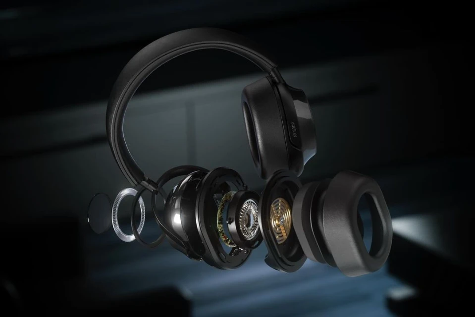 Detailed studio shot of deconstructed black headphones showcasing internal components, emphasizing technology and audio engineering.