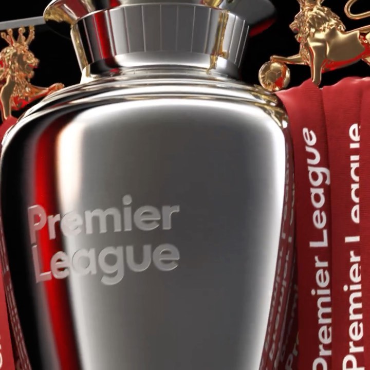 Close-up of Premier League trophy with gold lion statues and branded ribbons. Sports and championship theme with metal textures.