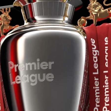 Close-up of Premier League trophy with gold lion statues and branded ribbons. Sports and championship theme with metal textures.