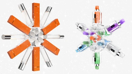 Two symmetrical arrangements of cosmetic bottles and orange boxes forming snowflake shapes on white background
