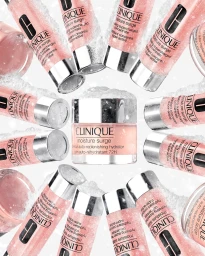 Clinique Moisture Surge jars and tubes arranged in a circular pattern surrounded by snowy textures against a white background