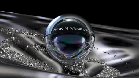 Spherical chrome product packaging resting on a reflective metallic draped surface by xk studio