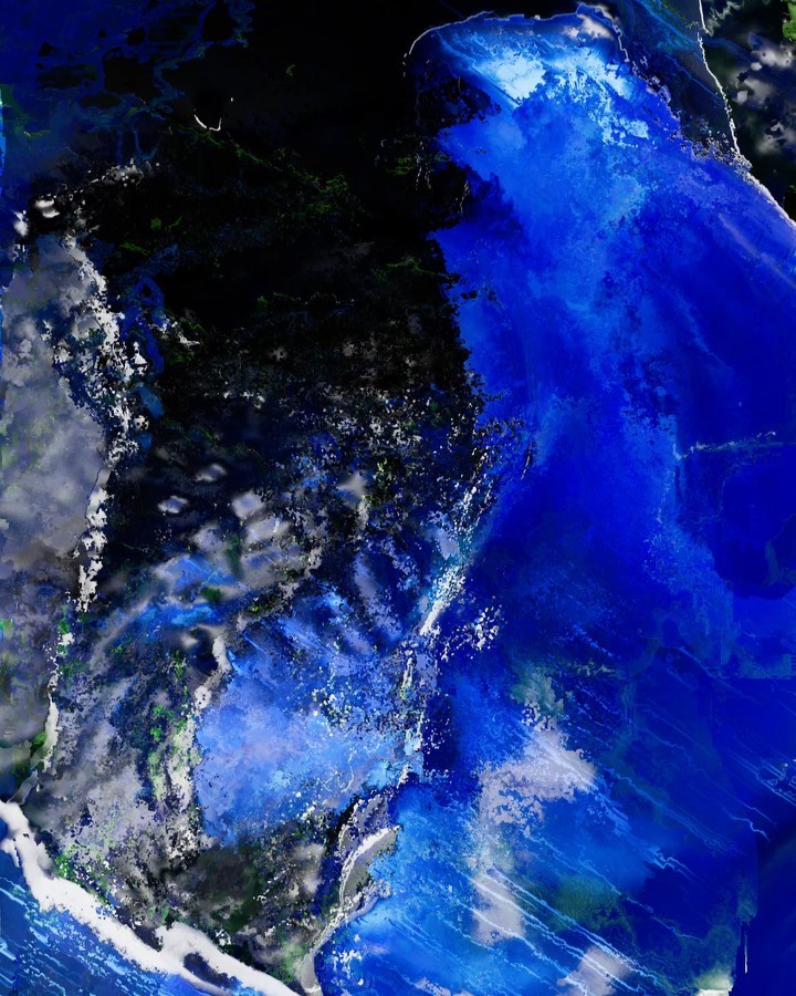 Aerial view of a large body of water with varying shades of blue, surrounded by dark landmasses, creating a dynamic landscape.