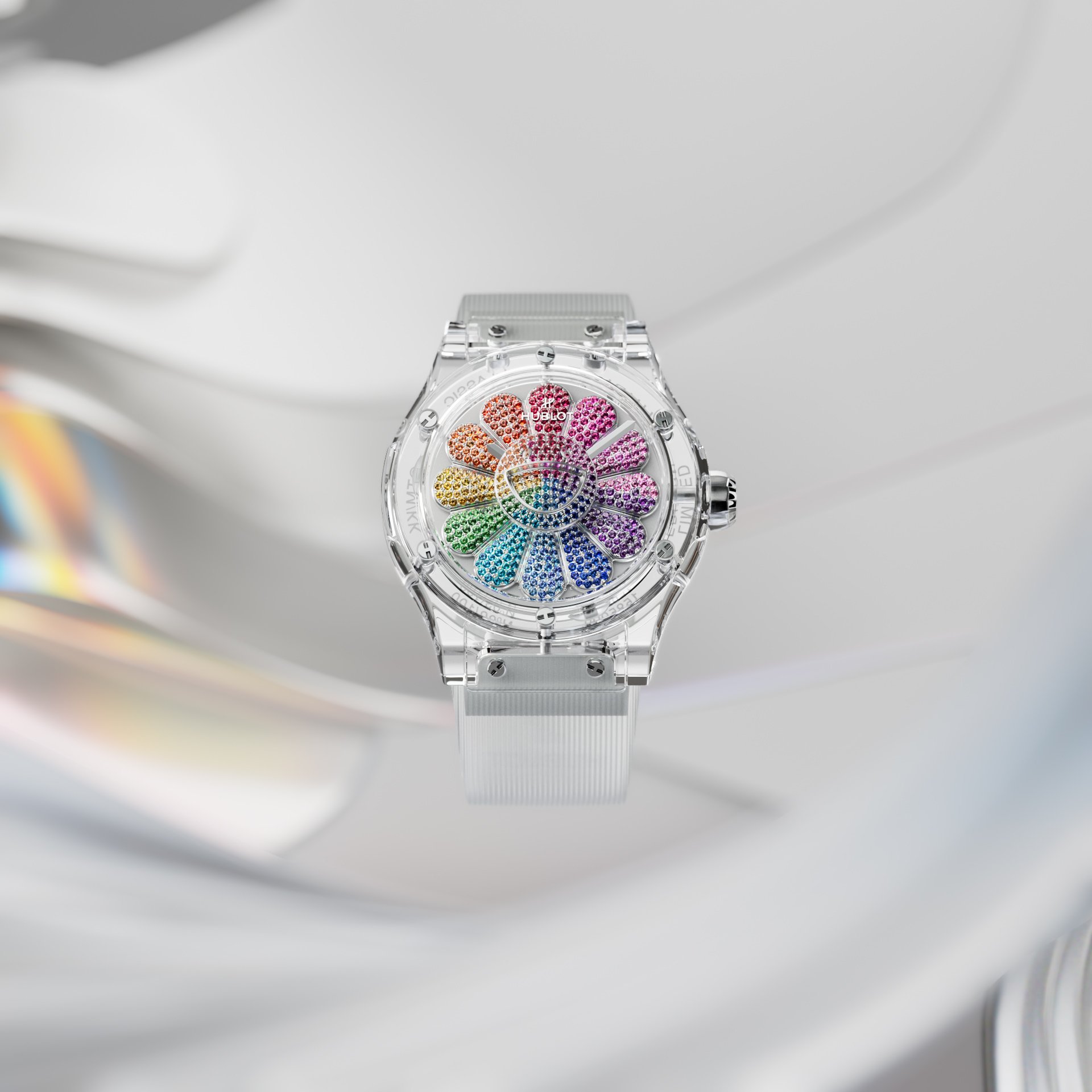 Elegant watch with a transparent band and a rainbow-colored, flower-shaped face, set against a bright, rippled reflective background.