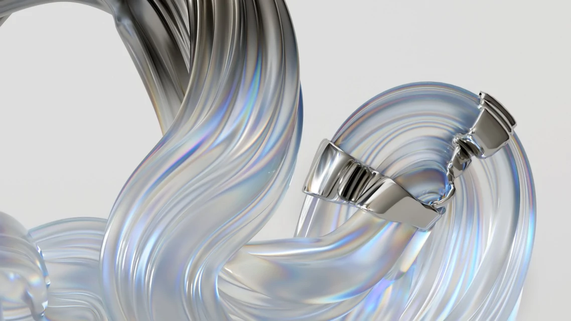 Abstract wavy glass sculpture with metal accents against a plain white background, showcasing cool-toned, reflective, and smooth textures.