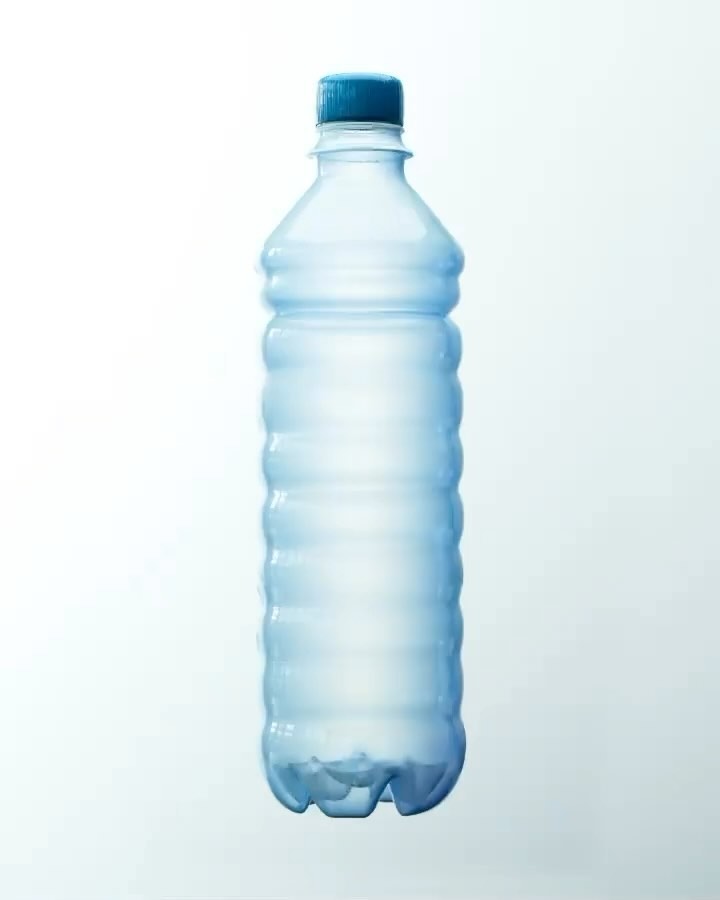 Clear plastic water bottle with a blue cap, isolated against a light blue background, showing its shape and design.