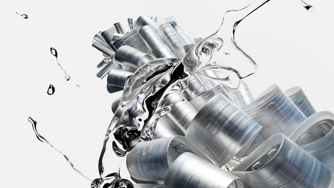 Abstract close-up of flowing, clear water interacting with a pile of metallic, silver tubes on a stark white background.