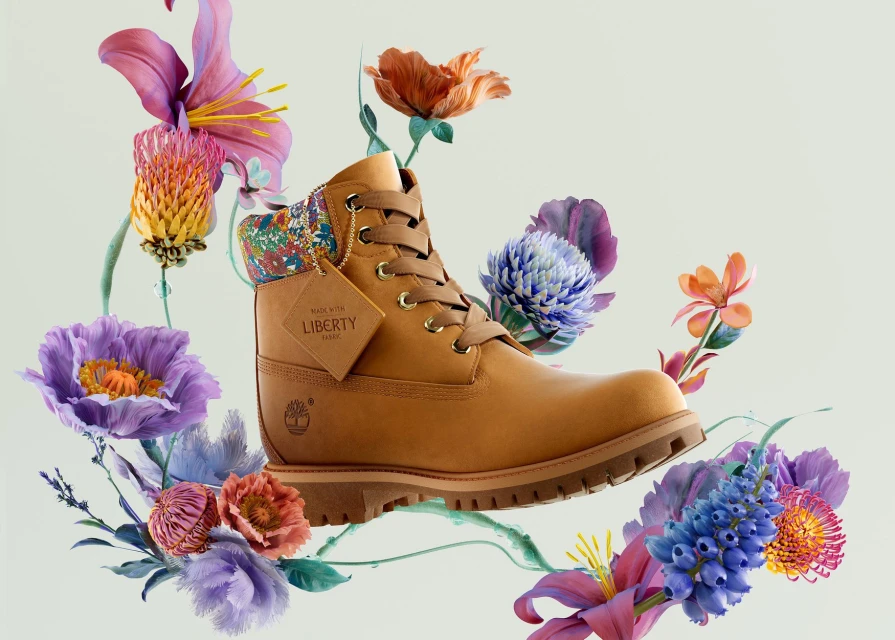 Tan Timberland boot surrounded by vibrant flowers in a studio setting showcasing fashion footwear for the modern consumer.