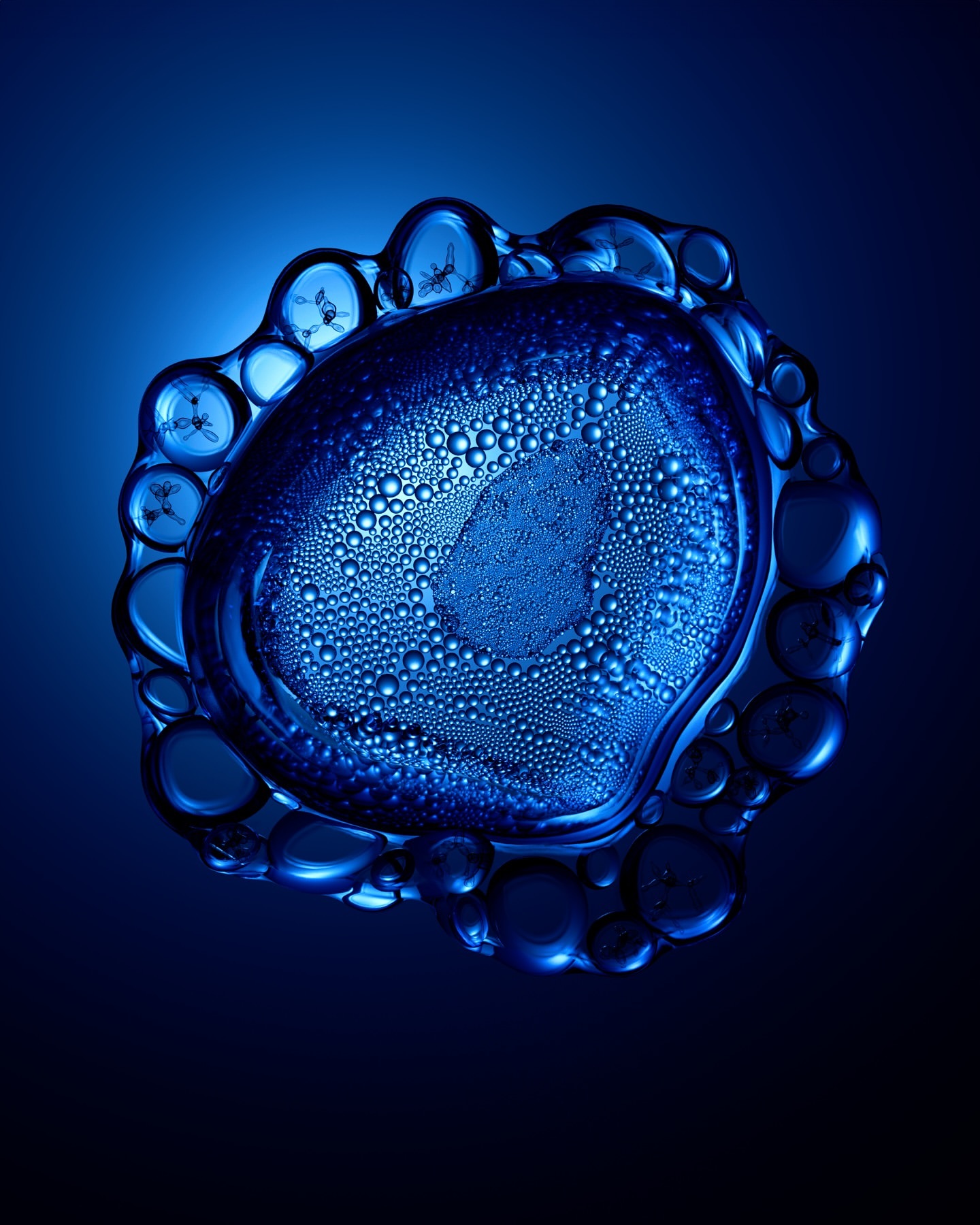 Macro photograph of a semi-translucent blue gel with internal bubbles and droplets, set against a matching blue gradient background.