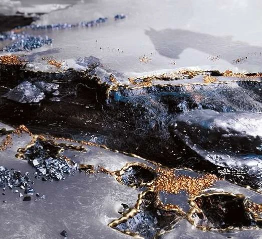 Abstract digital rendering features metallic textures, gold and blue accents, and unique patterns, creating a luxurious background image.