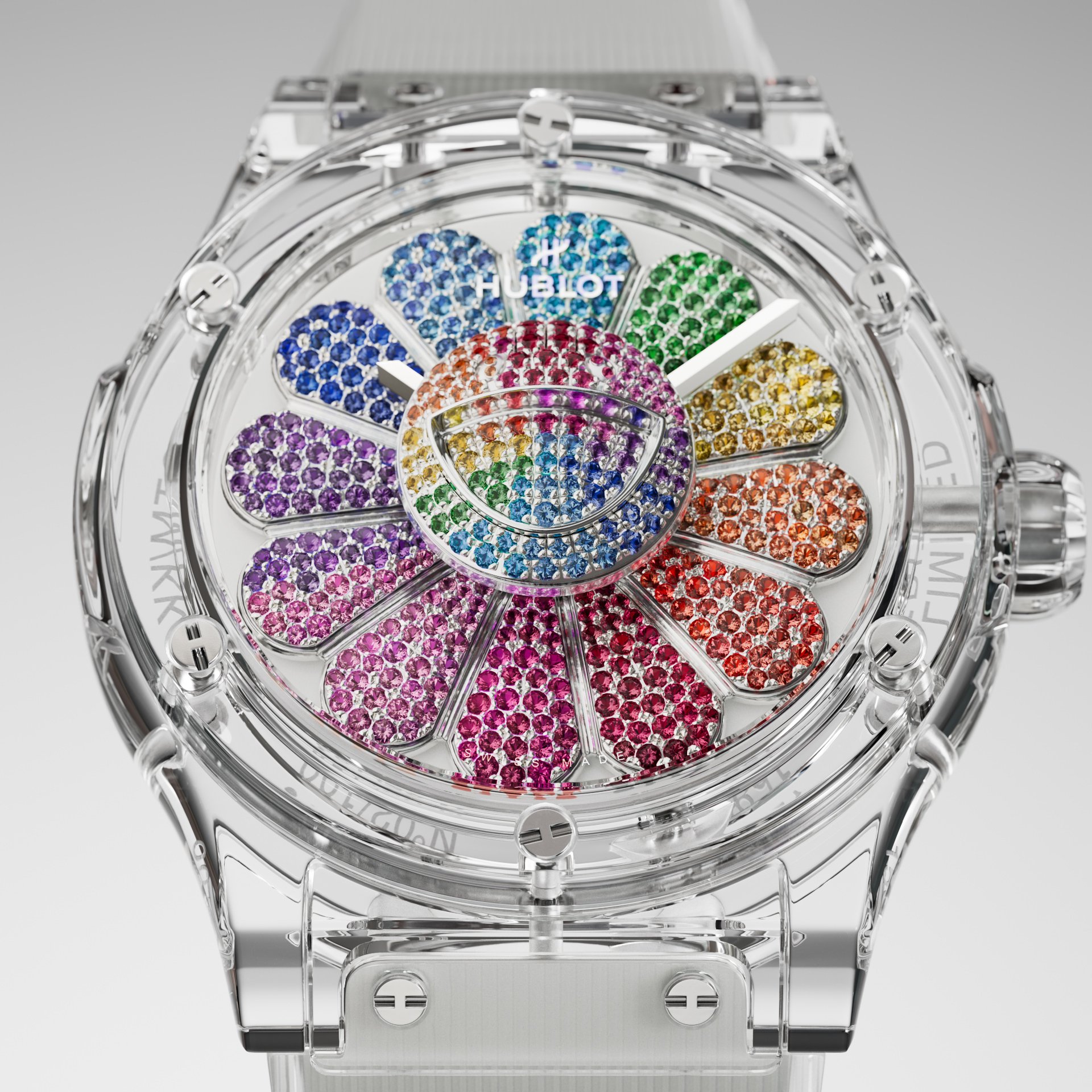 Close-up of a transparent Hublot watch face featuring a colorful jeweled flower design with rainbow detailing and gemstone accents.