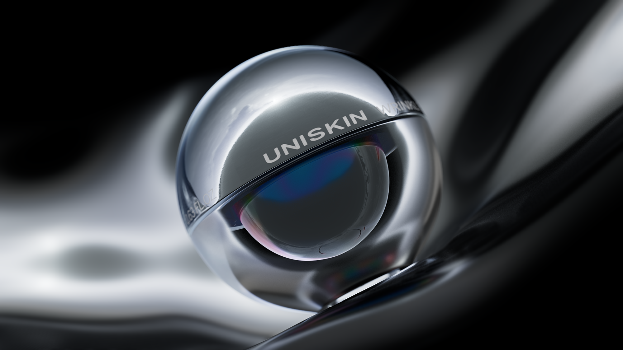 Polished chrome spherical object featuring the engraved text UNISKIN resting on a dark reflective liquid-like surface