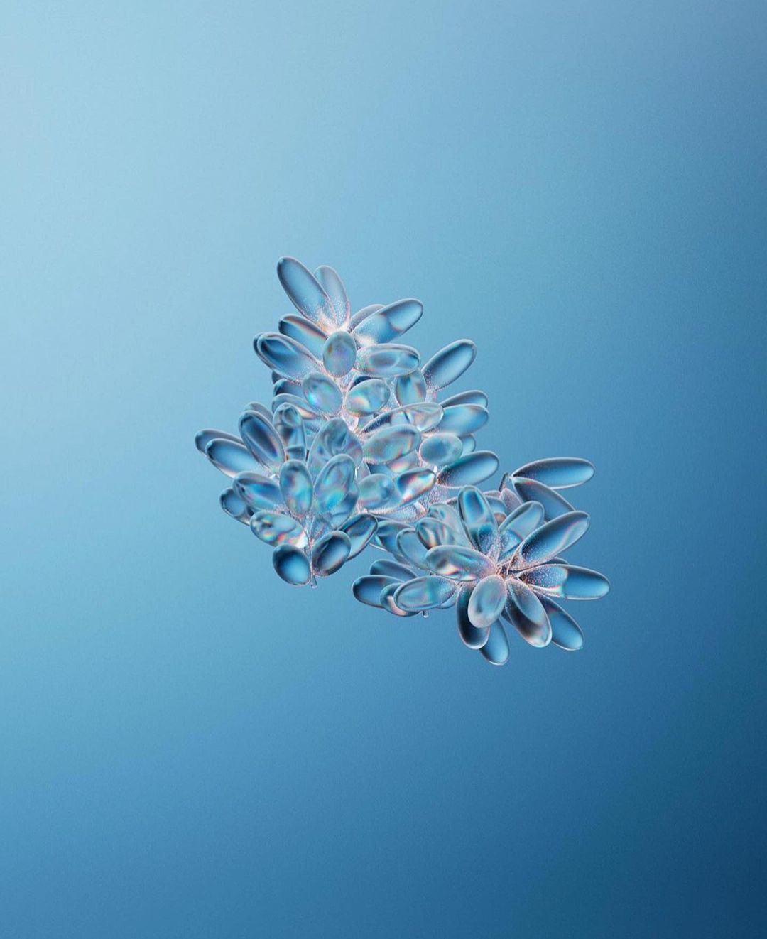 Close-up of a translucent flower-like crystalline structure with petal-like shapes against a graduated blue background.