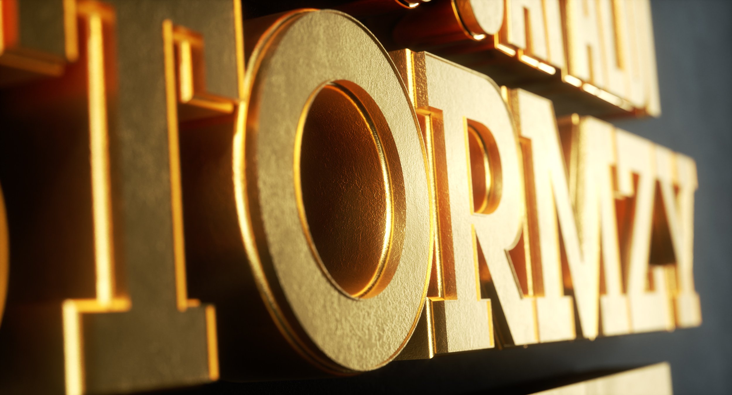 Close-up shot of 3D gold text, possibly a title or logo, with a shallow depth of field highlighting textures.