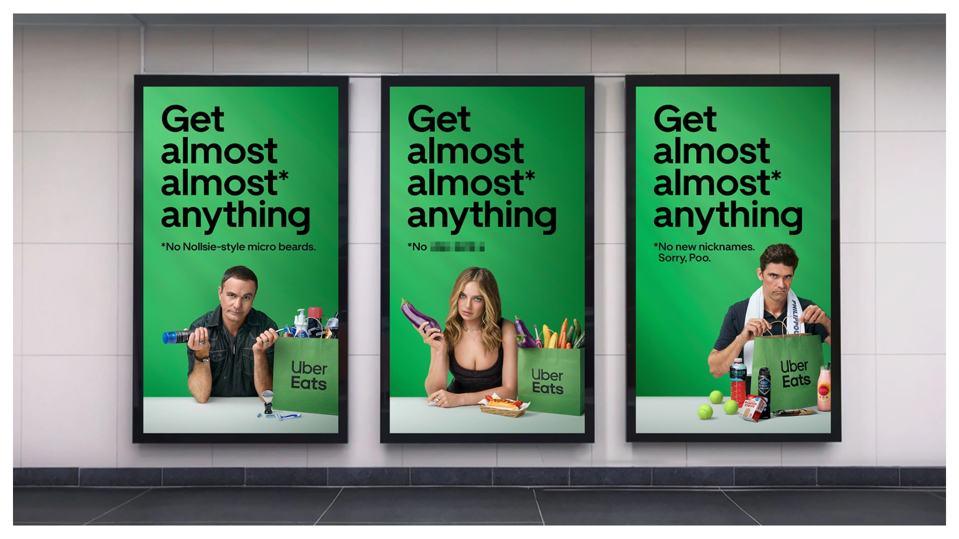 Three posters advertise Uber Eats with images of adults and food. The ads are displayed on a textured wall.