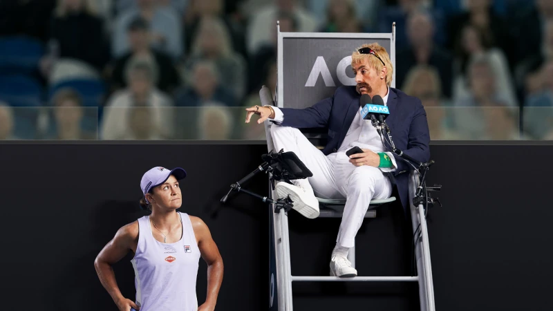 Tennis player in white sports apparel standing below an umpire chair with a man in white trousers and blazer gesturing.
