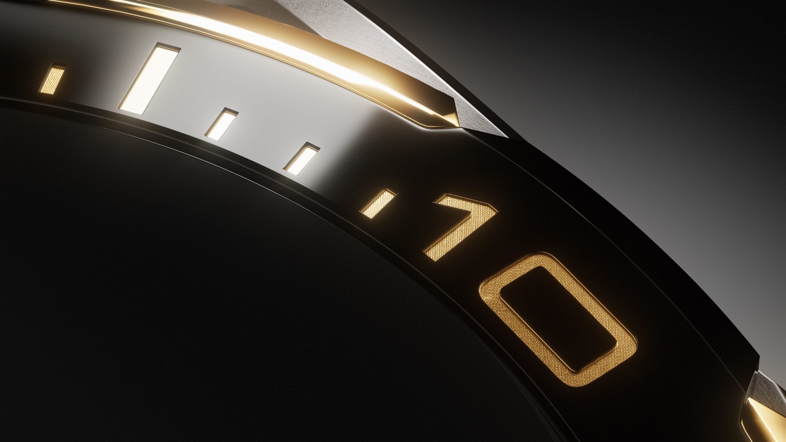 Close-up shot of a luxury black watch bezel with gold numeric markings, showcasing intricate detail and design in a studio setting.