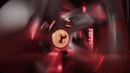 Close-up of a red Ferrari wheel and spinning spokes with visible motion blur and bright red brake calipers.