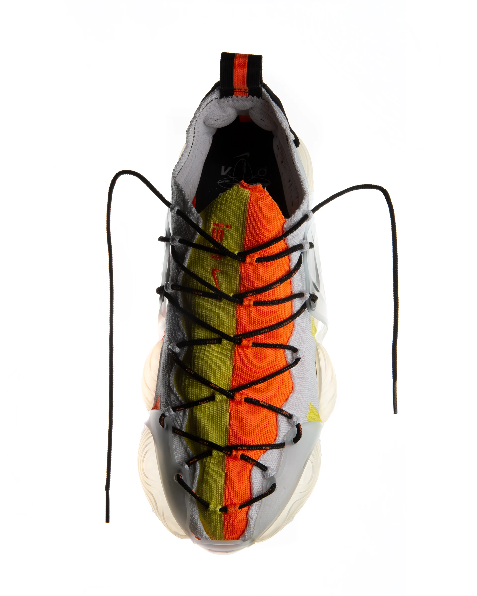 Top-down view of a white running shoe with black laces, featuring orange and lime green accents on a white background.
