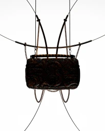 A quilted handbag suspended by thin metal cables and chains against a clean white background, created by Joy Cgi.