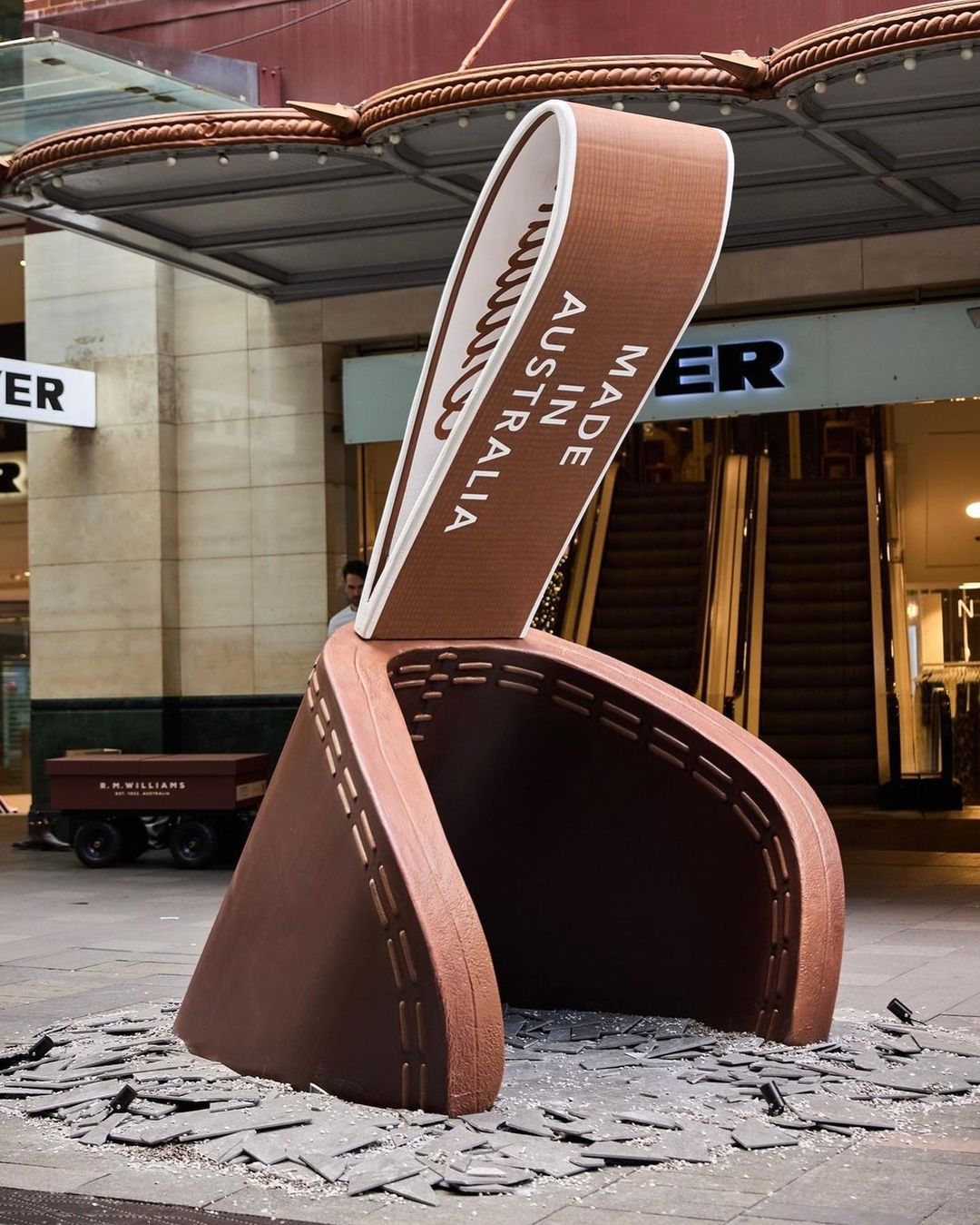 Giant leather boot sculpture in an urban setting with paving stones. Text on the boot reads: Made in Australia.