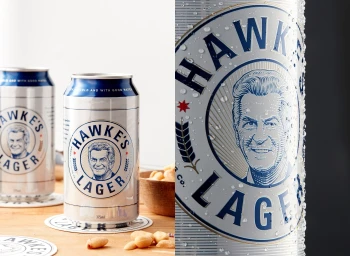Close-up product photography of a cold aluminum beer can with water droplets, featuring illustrated branding, styled by Kalliroy Edlin.