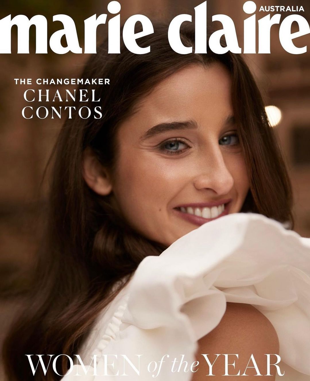 Magazine cover featuring a smiling woman with brown hair wearing a white ruffled top, with 'Marie Claire Australia' and 'Women of the Year' text.