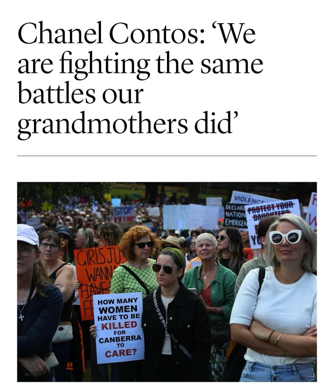 Crowd of women at an outdoor rally. Protesters hold signs with messages about women's rights. Demonstrators standing together.