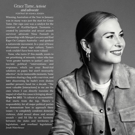 Black and white portrait of Grace Tame in a suede jacket, smiling slightly, with natural light highlighting her features and simple jewelry.