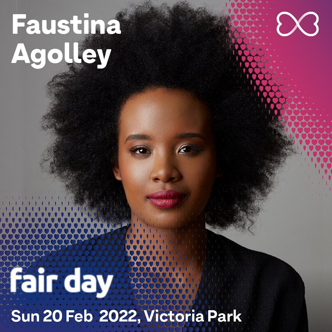 Portrait of Faustina Agolley with large afro hairstyle, wearing a black blazer, against a backdrop of blue and pink hearts.