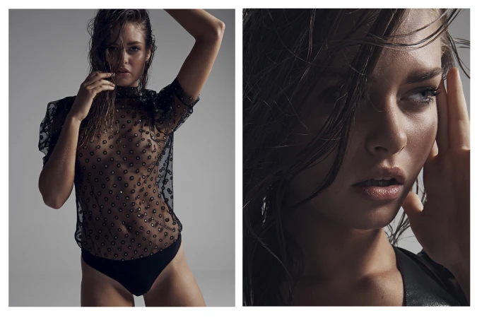 Studio portrait of a brunette woman with wet hair wearing a sheer black top and briefs against a gray backdrop.