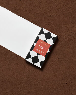 Edco Black Moreish Milk chocolate bar with a black and white diamond pattern on a brown background with a white stripe.