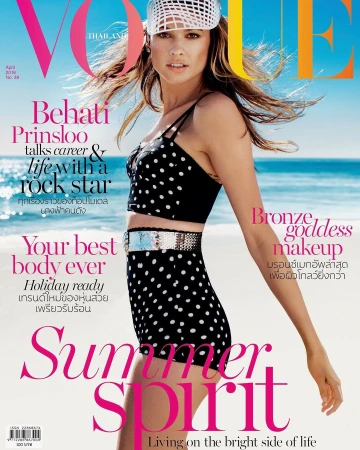 Vogue Thailand cover featuring Behati Prinsloo in a polka-dot bikini and white hat, on a beach with blue sky and ocean backdrop.