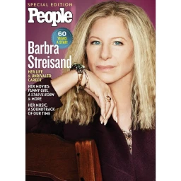 Portrait of Barbra Streisand with long blonde hair and bracelets resting hand on chin for People magazine cover photographed by Russell James.