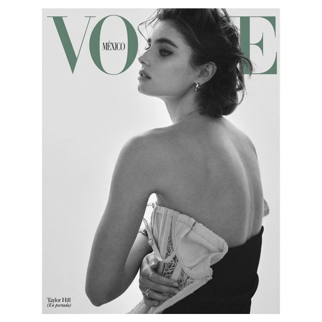 A fashion magazine cover features a fair-skinned woman with dark hair, glancing left over her shoulder. She wears a strapless top against a clean white backdrop.