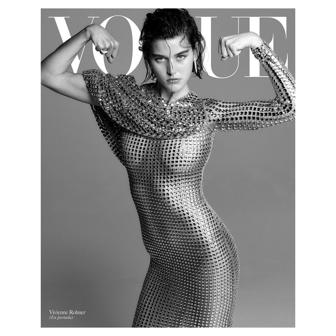 Black and white magazine cover featuring a woman in a metal dress posing with wet hair and raised arms, with the magazine's title at the top.