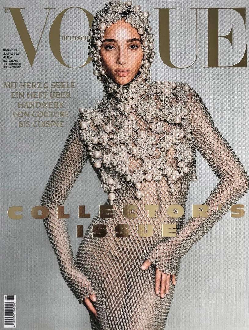 Vogue magazine cover featuring a model in a pearl-beaded headpiece and a metal mesh dress against a textured gray background.