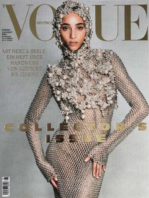 Vogue magazine cover featuring a model in a pearl-beaded headpiece and a metal mesh dress against a textured gray background.