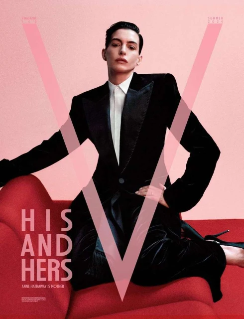 Magazine cover featuring an adult woman with short, dark hair, wearing a black tuxedo and heels, posing on a red chaise lounge against a pink backdrop.