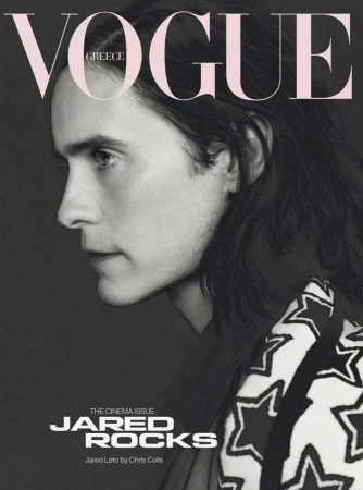 Jared Leto in a monochrome fashion portrait for Vogue Greece, featuring a star-patterned garment against a grey backdrop with bold typography.