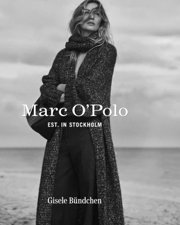 Black and white fashion shot of Gisele Bundchen in a long knit coat and scarf on a beach, promoting Marc O'Polo. Moody, natural light.