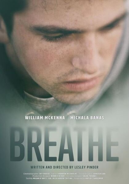 Close-up of a young adult male looking down, with film credits overlaid. 'Breathe' is displayed prominently in large letters.