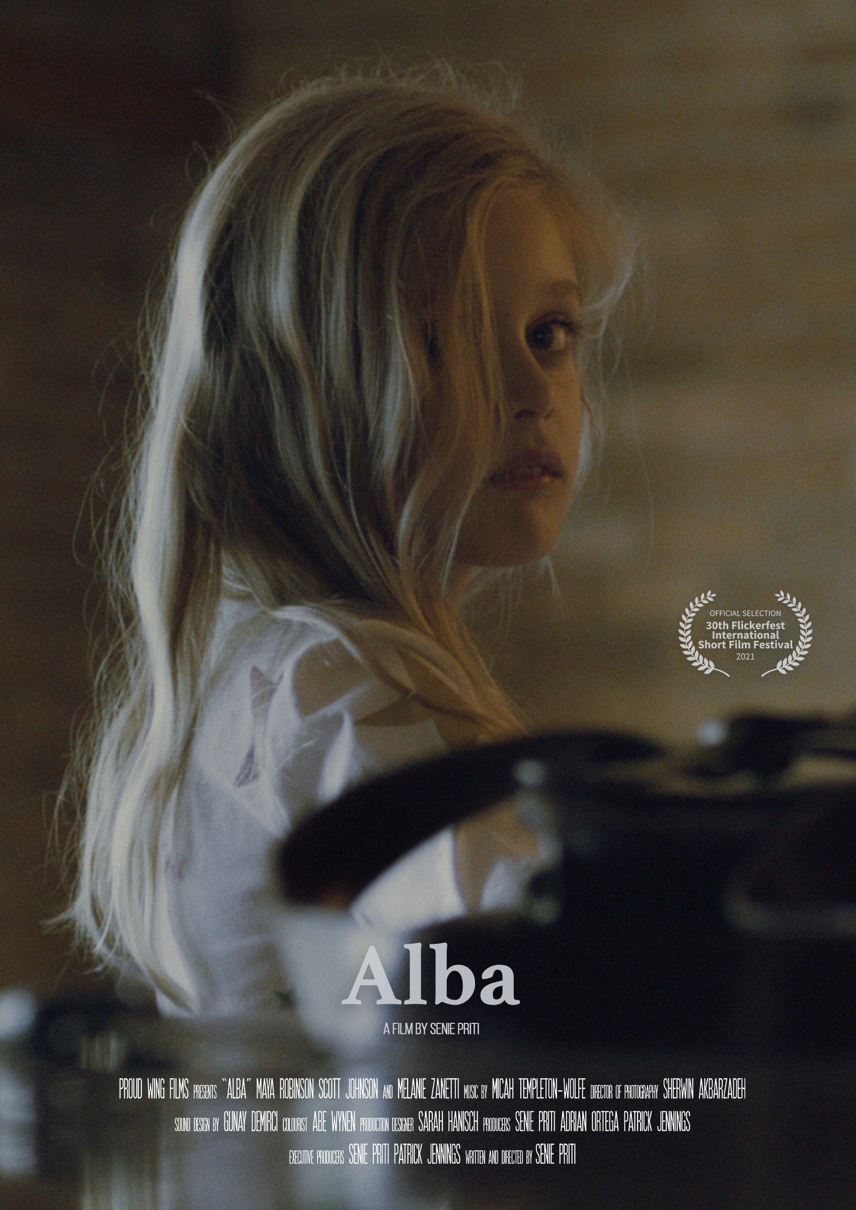 Film poster featuring a young girl with blonde hair, looking towards the viewer, with text reading 'Alba' and film credits.