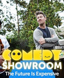 Outdoor gathering with an adult male smiling and standing near a barbeque grill, 'Comedy Showroom' text overlay in yellow on the foreground.